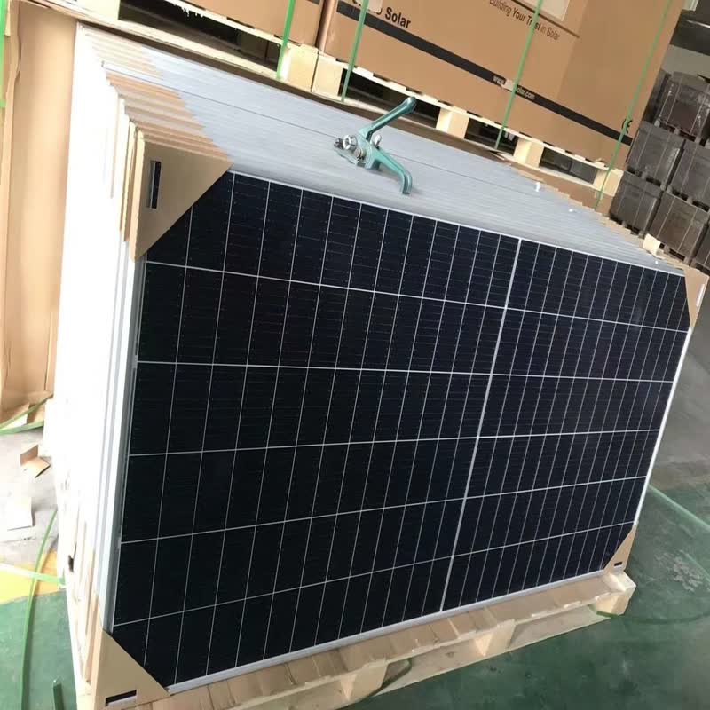 Jinko 615W bifacial solar panels stacked on a pallet.